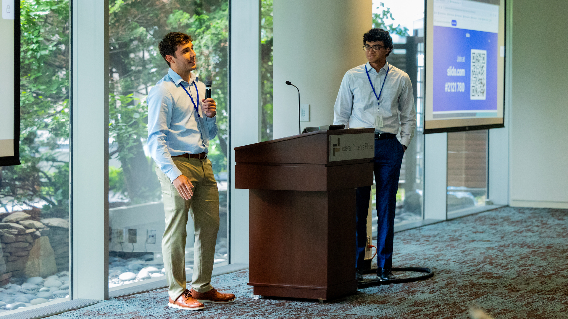 A photo of Liam Chentoufi and Brennan Jarvis speaking at the Reciprocal Mentoring event.